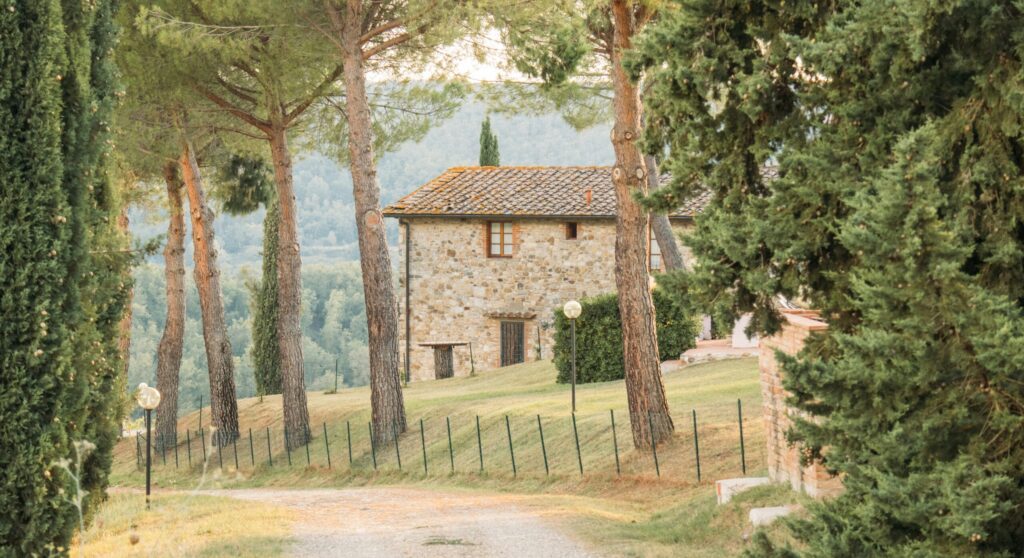 Villa in Tuscany, Italy seen through its trees and drive